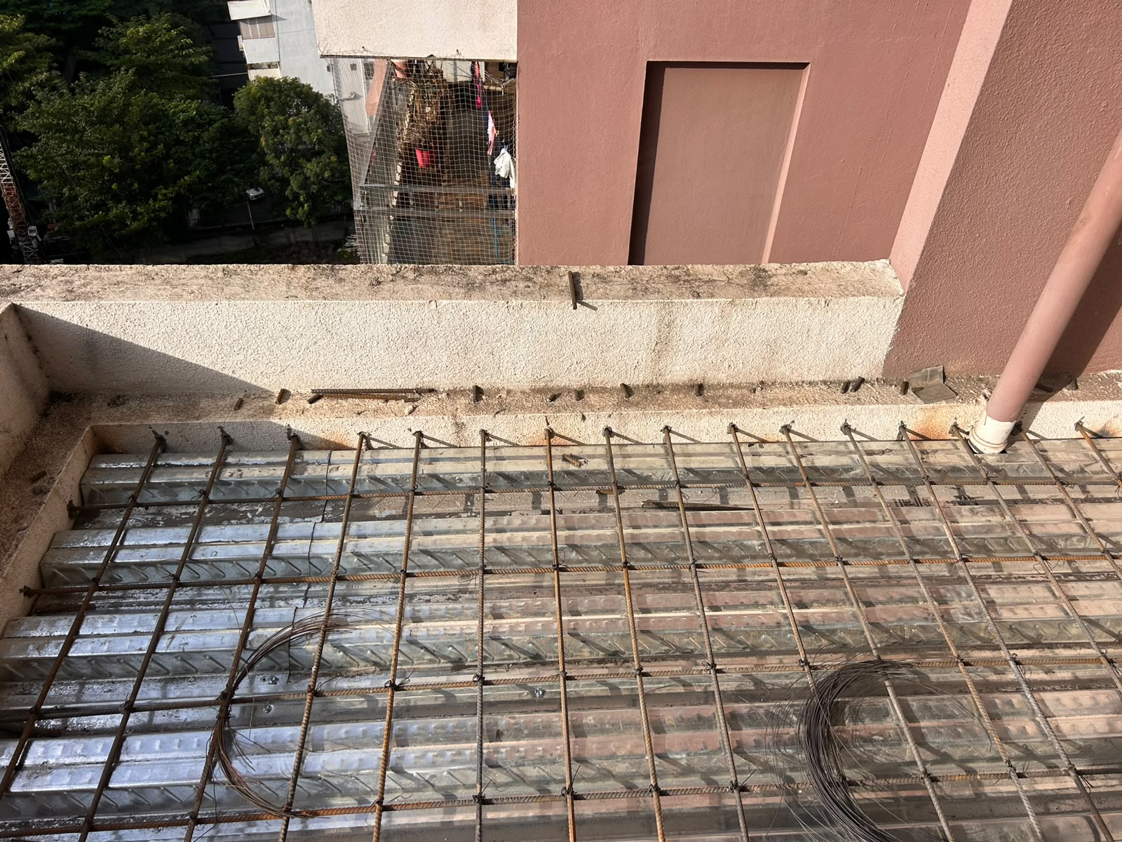 Balcony extension steel decking sheet and rebar mesh floor preparation in Pune by Morya Fabricators